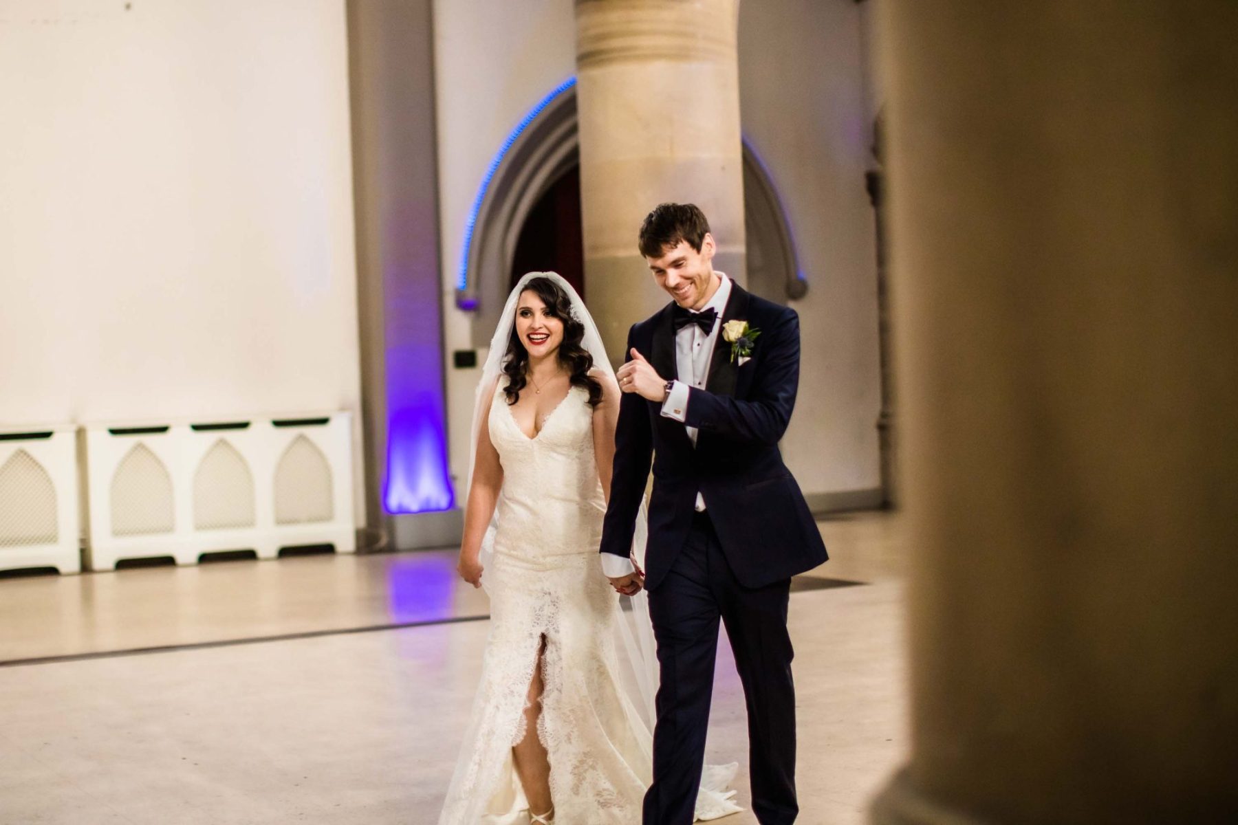 Bride and groom walking into their reception at Manchester Monastery