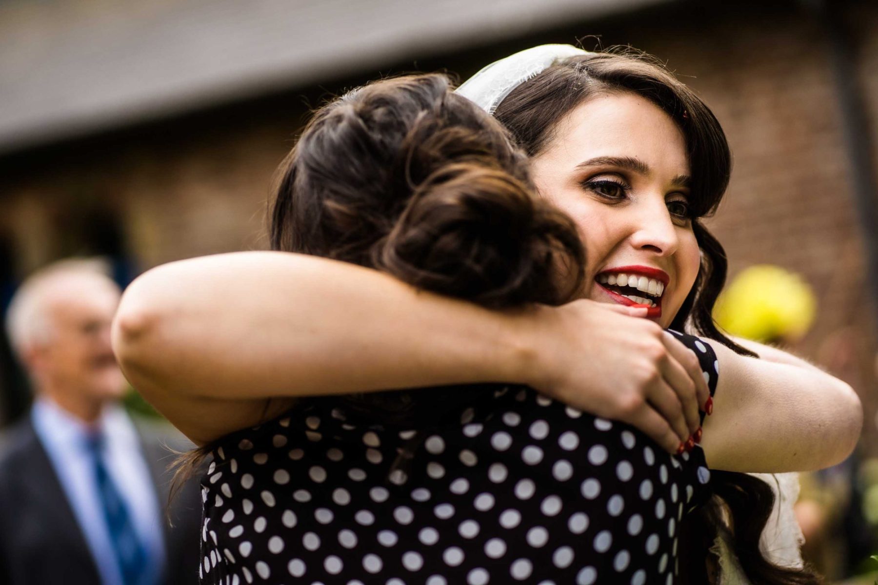 Bride hugging wedding guest