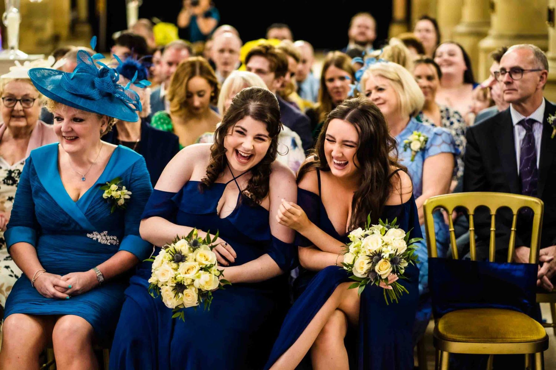 Bridesmaids laughing during wedding ceremony