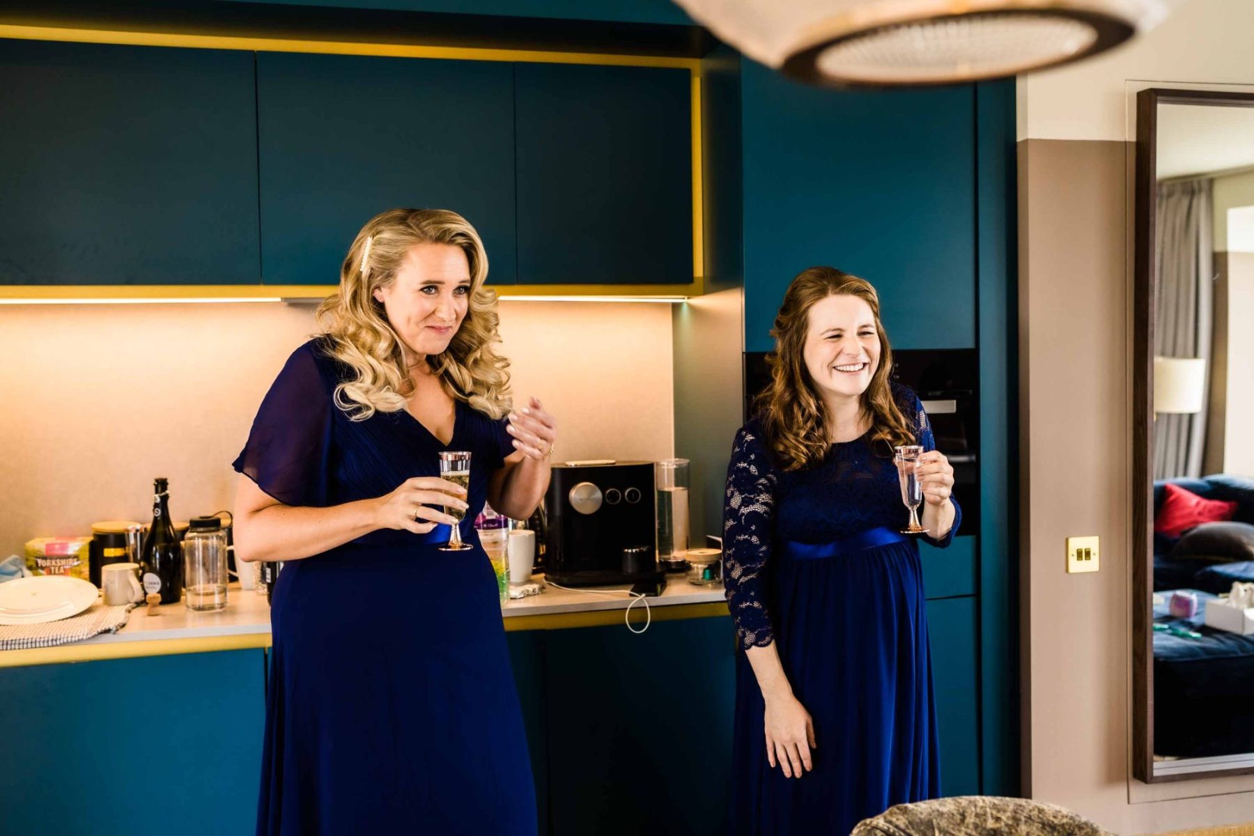 Bridesmaids laughing with champagne in their hands