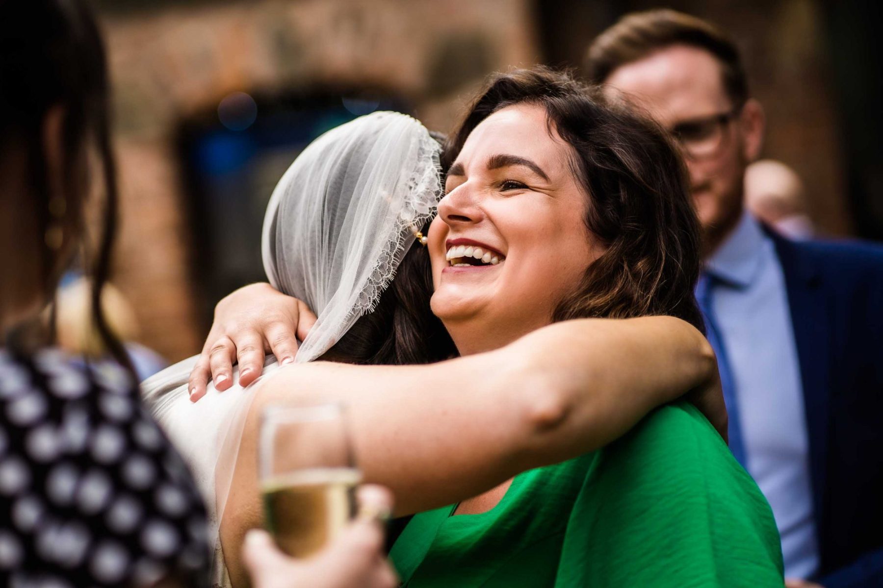 Guest hugging bride