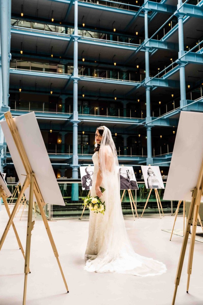 Vintage bride with long train looking over her shoulder