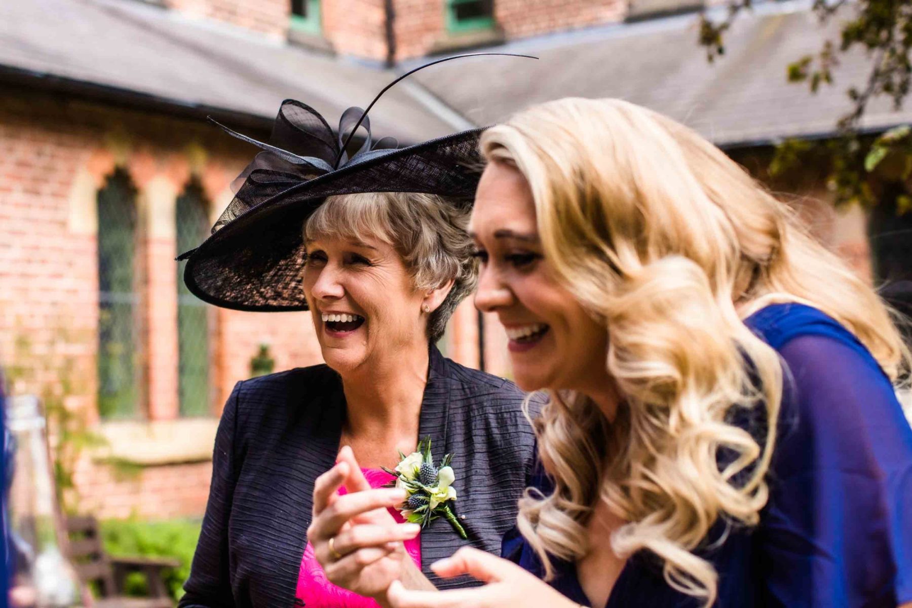 Wedding guests laughing with each other